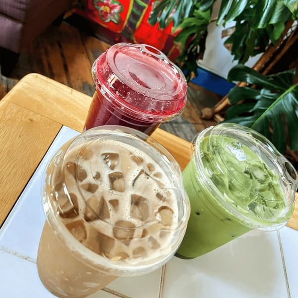 Three iced drinks: a red berry smoothie, an iced coffee, and a green matcha latte.
